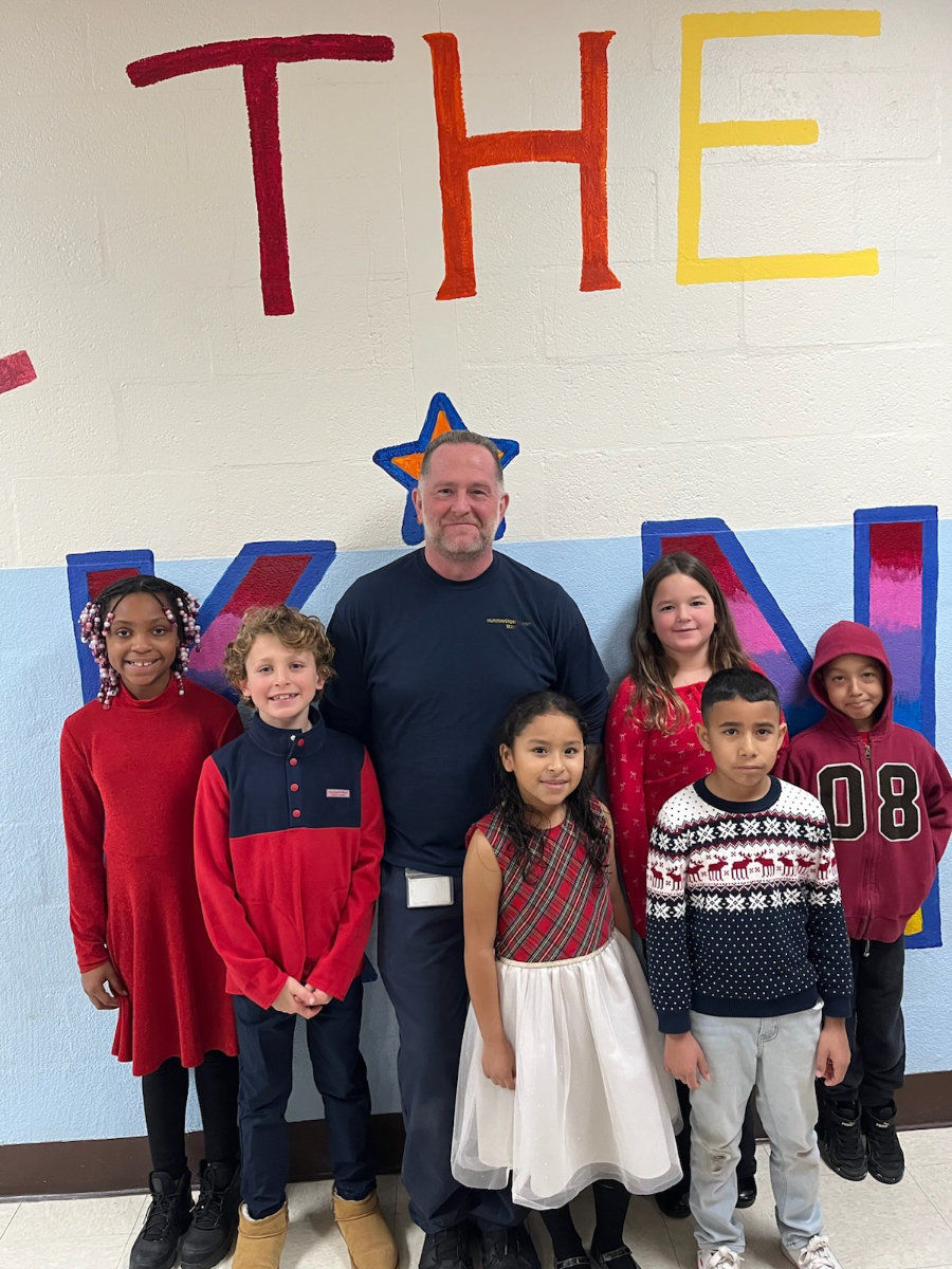  Head Custodian Bill Habel with Southdown students in a spotless hallway   