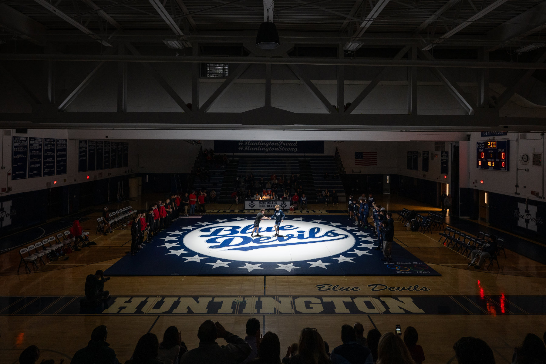  The Blue Devils wrestling on their new mat under a 50,000 watt mat lamp. (Darin Reed photo.)  