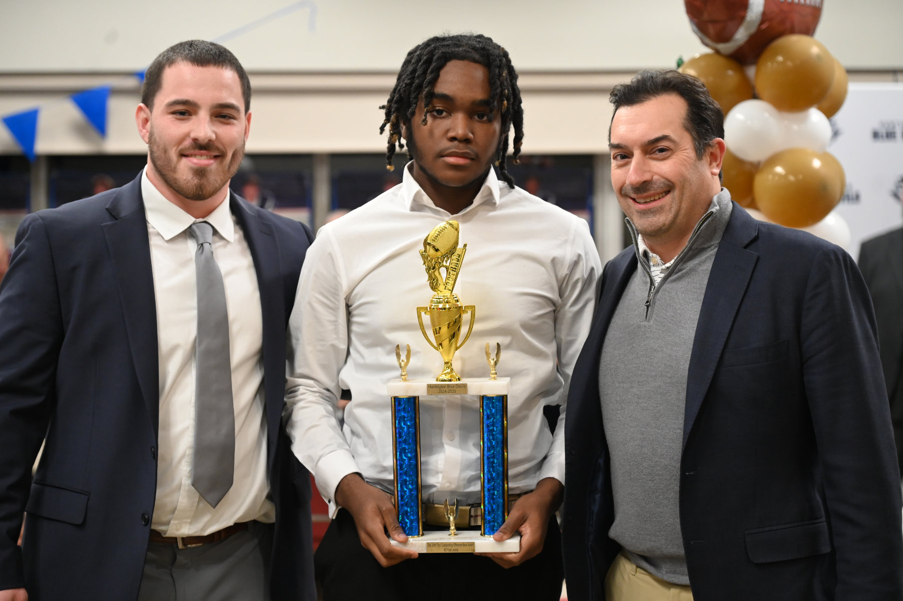 Junior Yasir Jones is flanked by Coach Anthony McDonald and Dr. James Paci