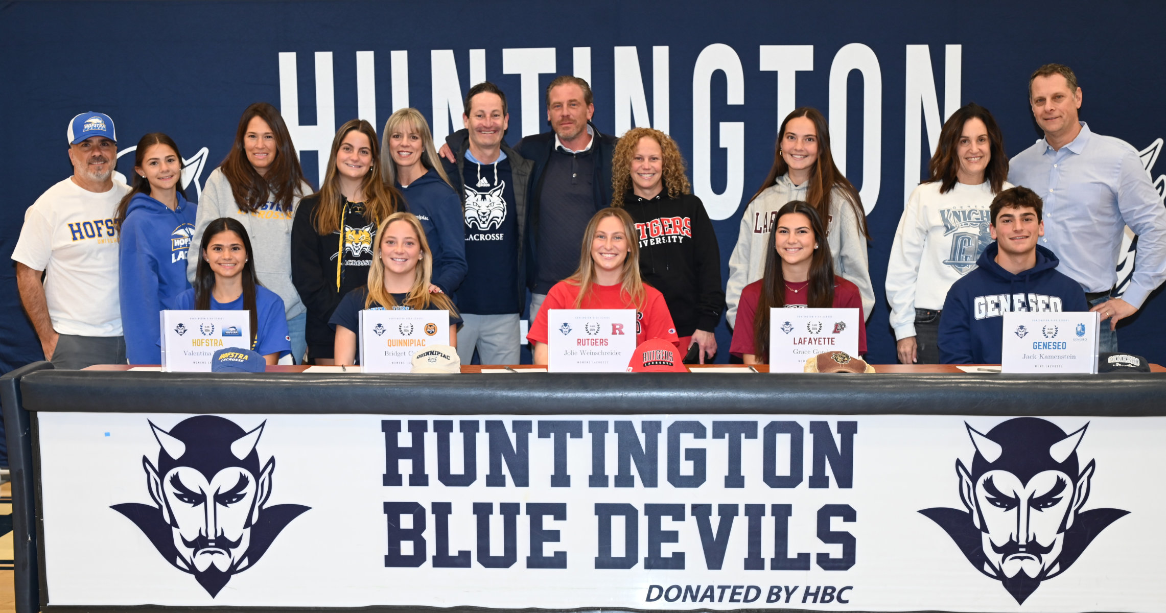  The five Blue Devil greats with their parents and siblings at the signing ceremony.   