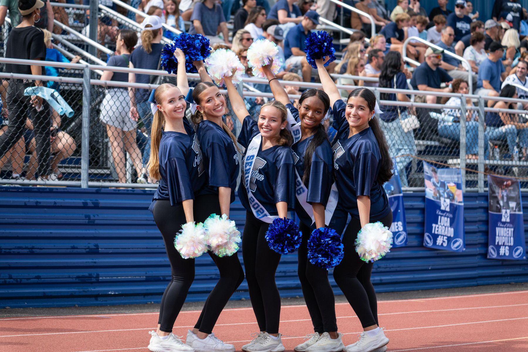  Kyra Larsen and Kymora Dorvilus are surrounded by their teammates. (Darin Reed photo.)  