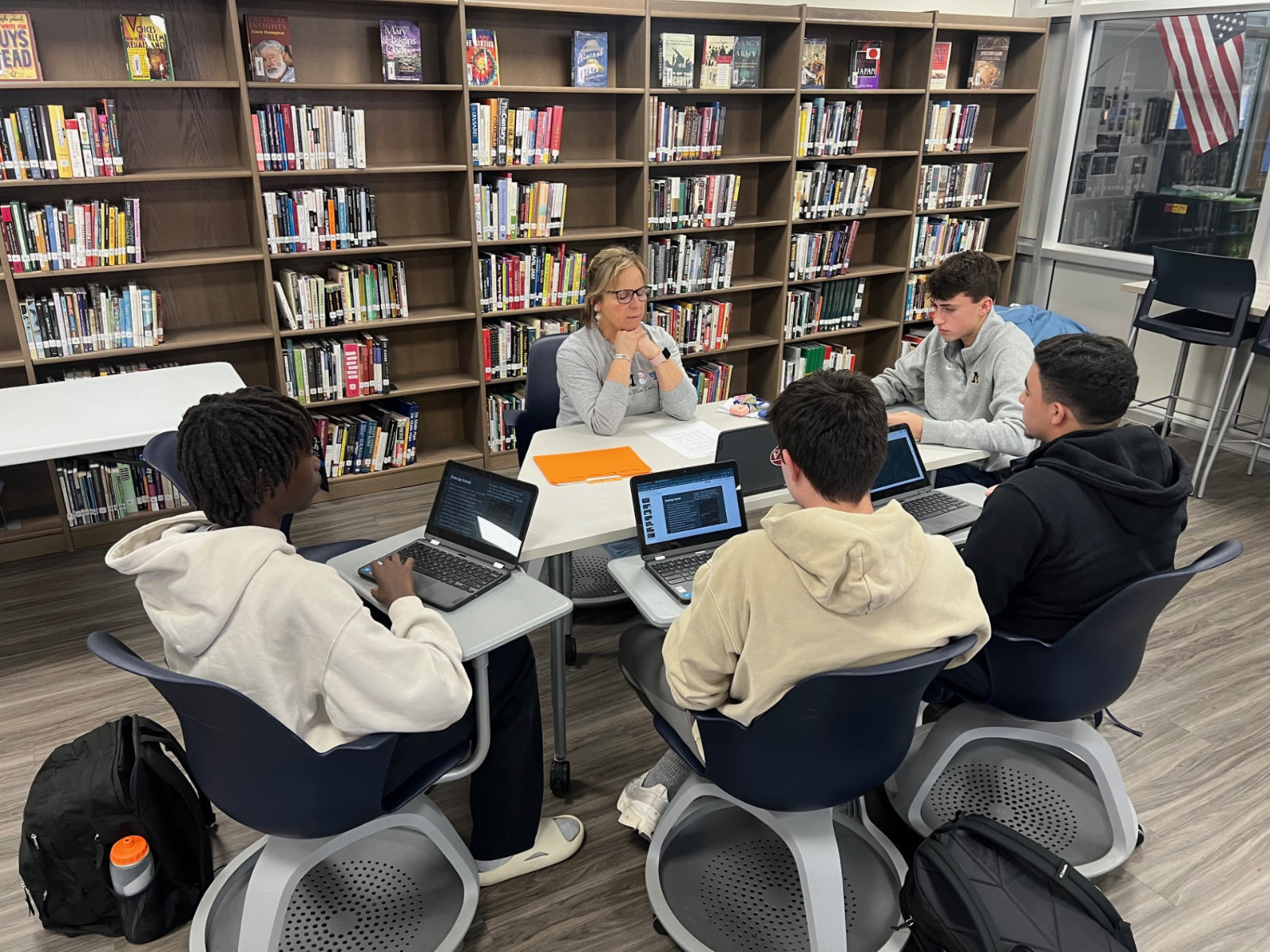  Teacher Suzi Biagi meets with a group of budding financial advisors.  