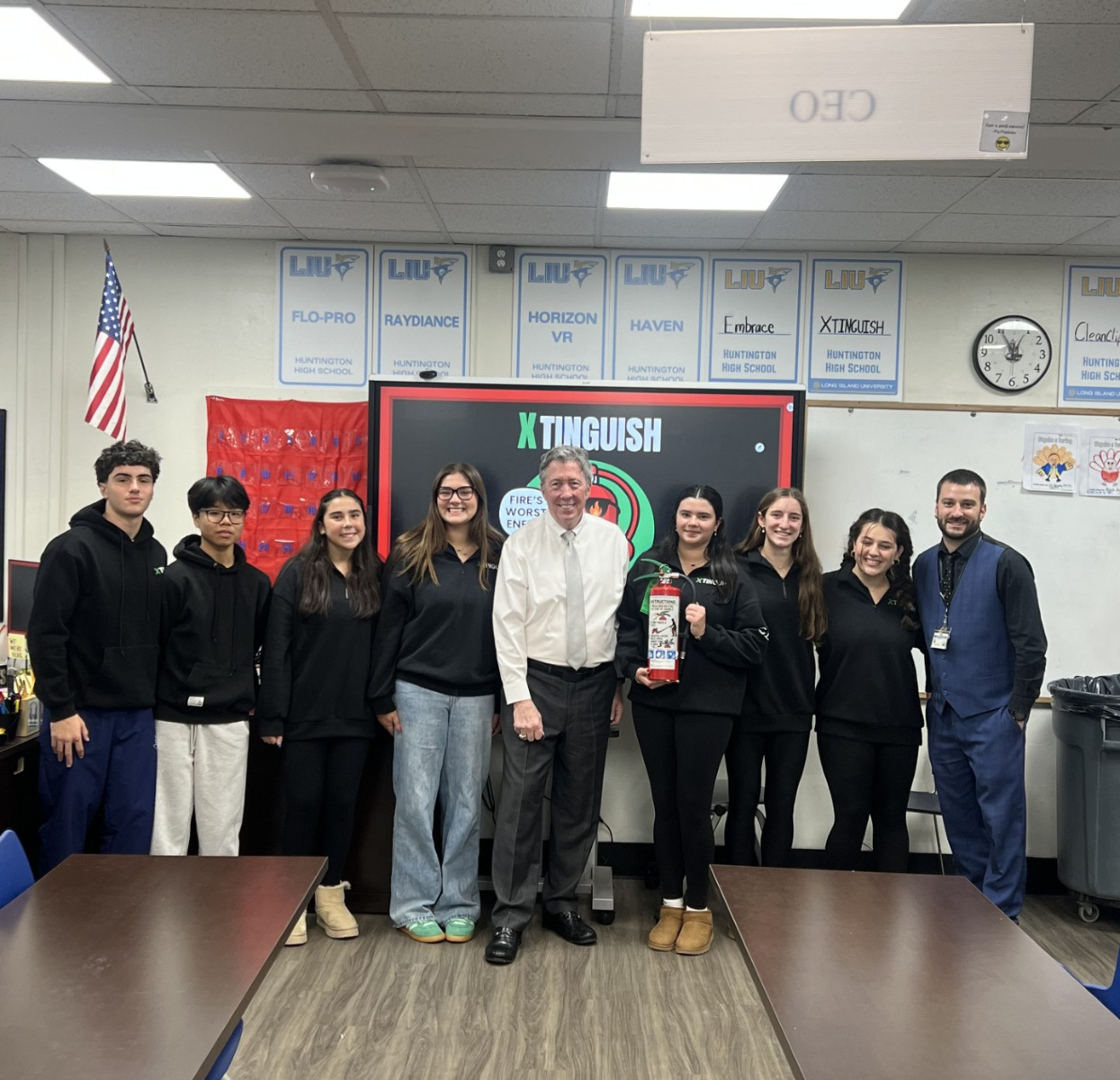  Christopher Bates with VE teacher Bryan Outsent (right) and Xtinguish executives.  