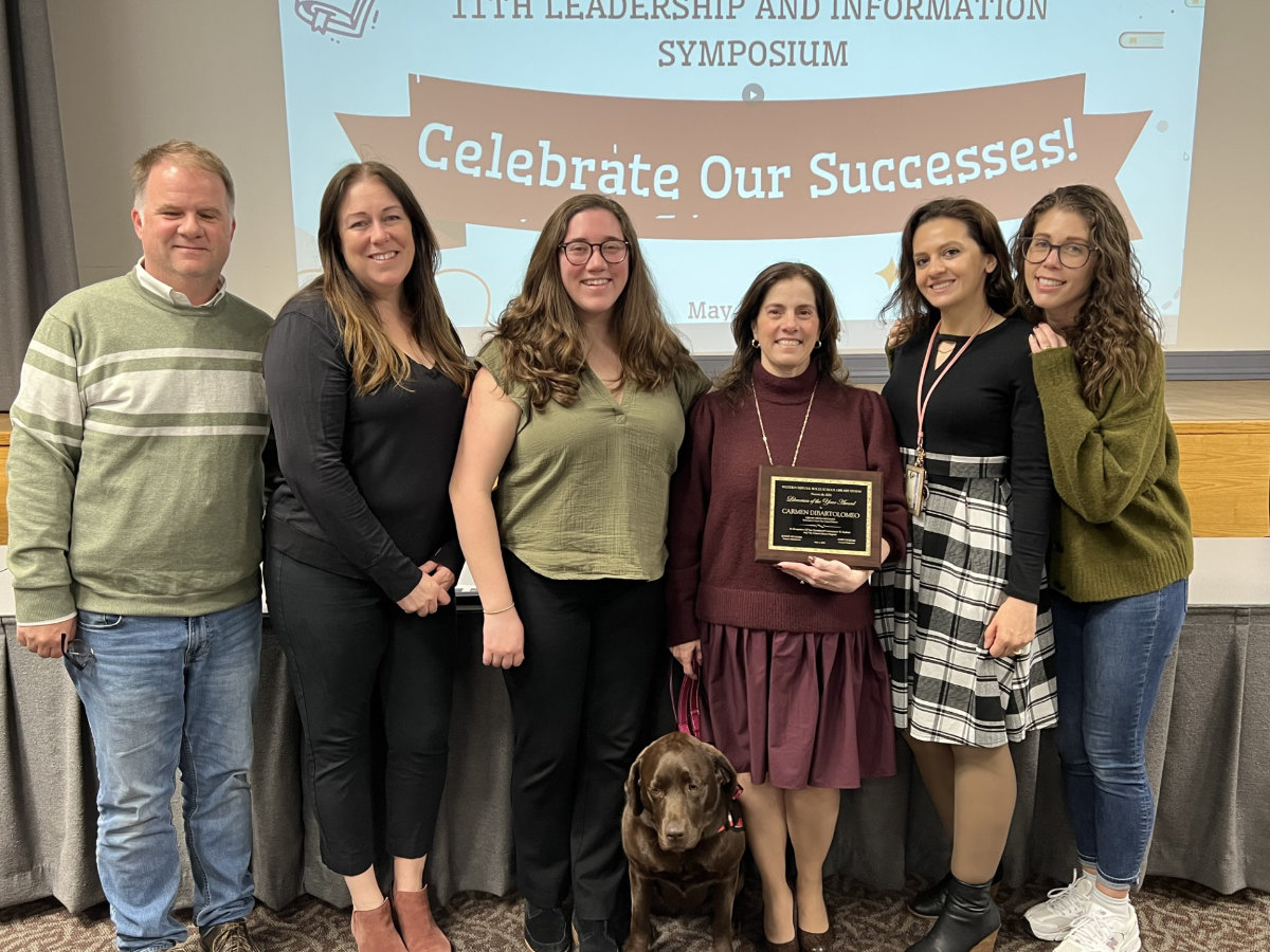  Finley's Carmen DiBartolomeo (holding plaque) has been named Librarian of the Year   