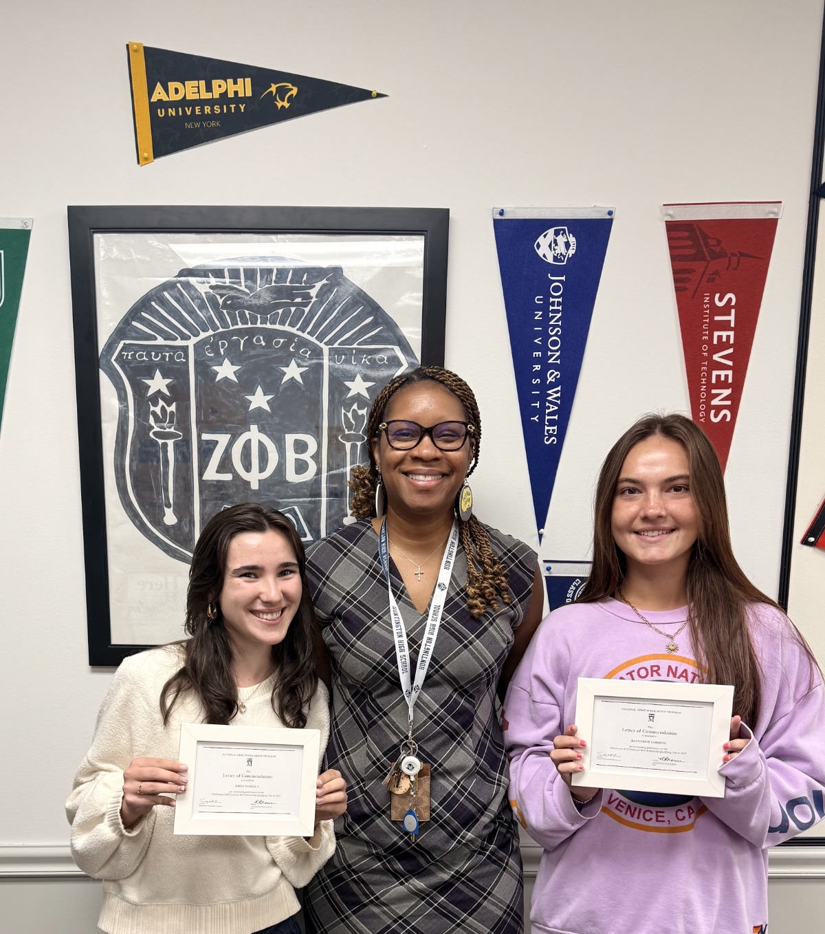  Emma Marsala (left)and Katherine Gordon flank proud Huntington High School Principal Rochelle Brown.  